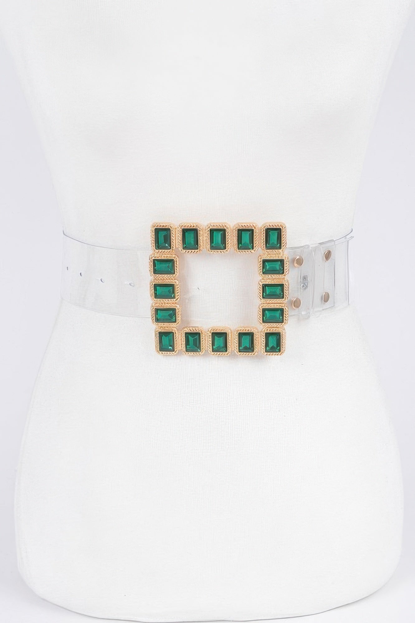 Stone buckle faux leather belt with square green gem accents on a clear strap