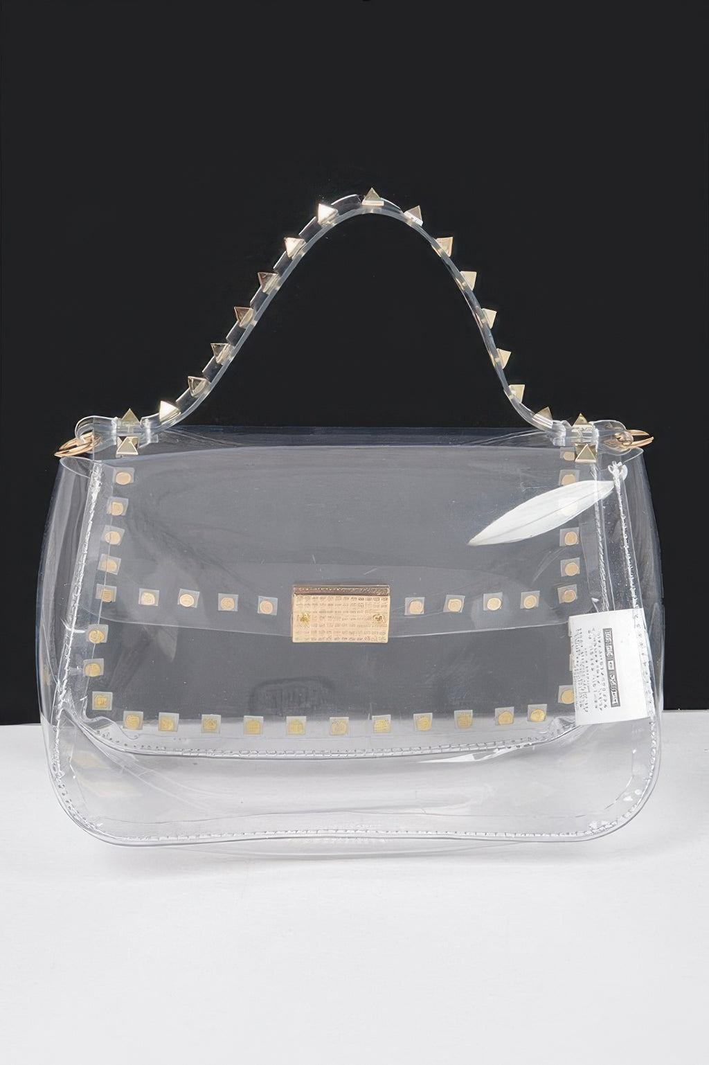 Clear top-handle bag with gold square center clasp and studded edges
