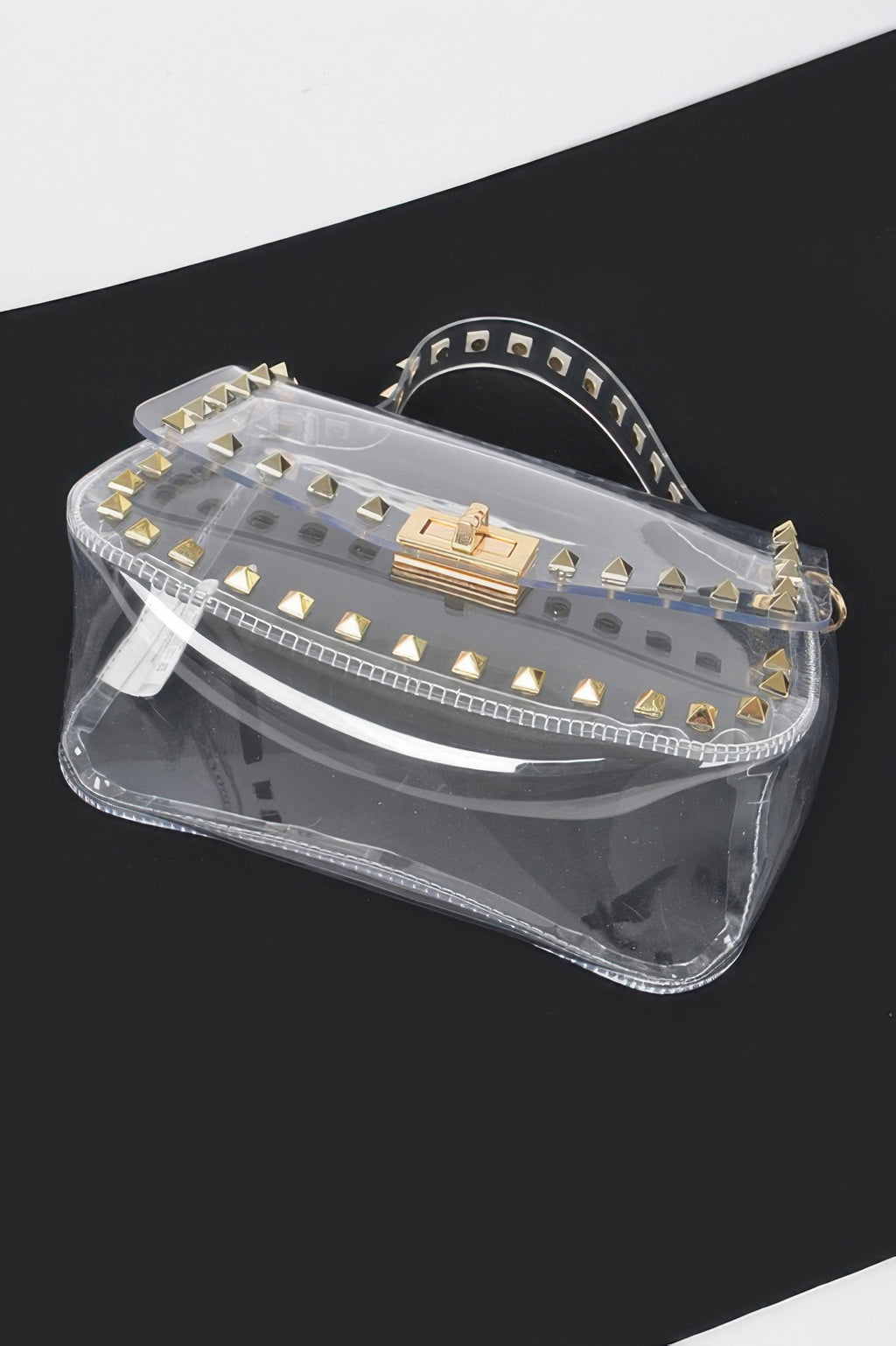 Transparent mini top-handle bag with gold studs and front buckle detail
