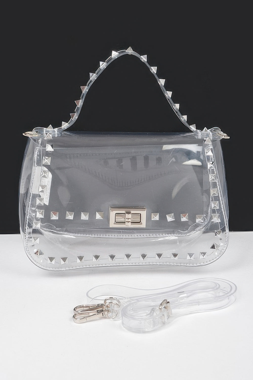 Clear top-handle bag with gold stud accents and adjustable strap