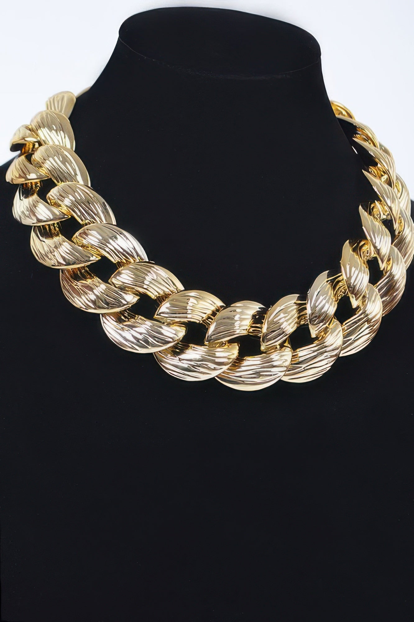 Oversized gold chain necklace, close view of interlocking oval links