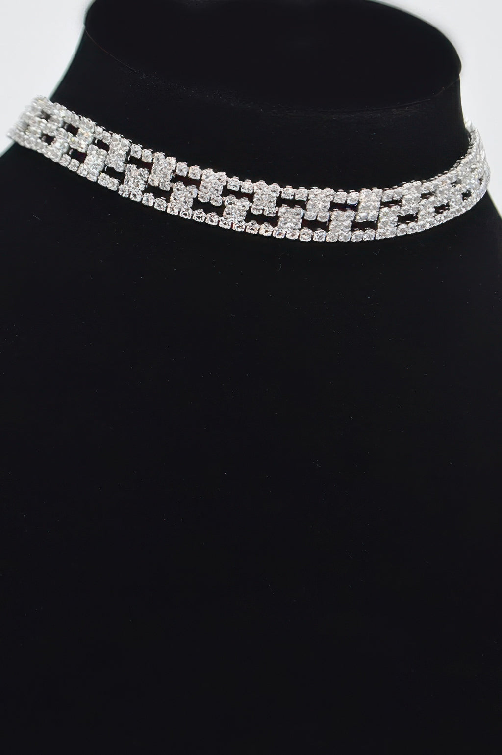 Rhinestone choker with repeating silver square settings along the band