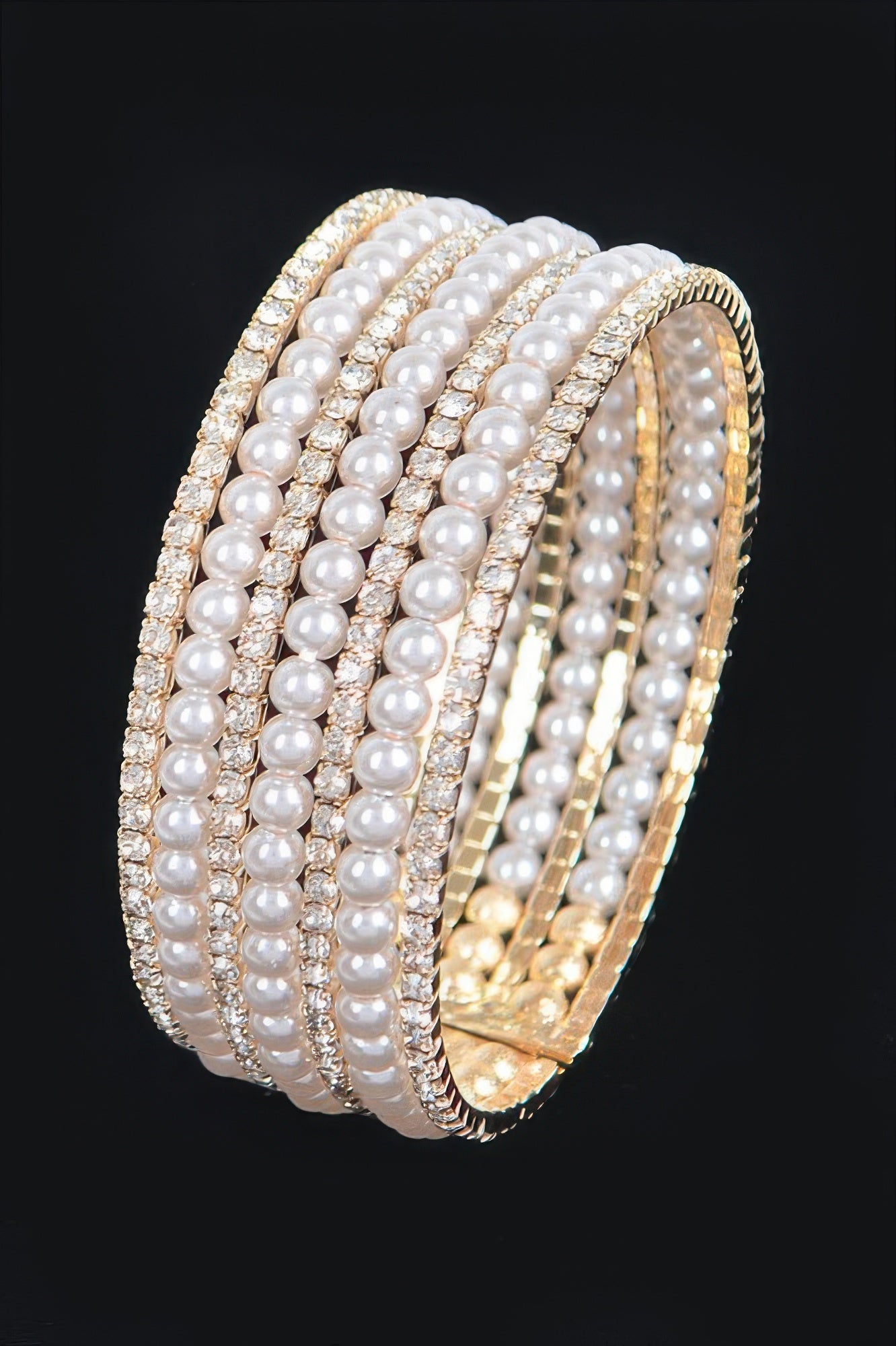 Gold wire bracelet with stacked white pearl rows and sparkling crystal trim, side view