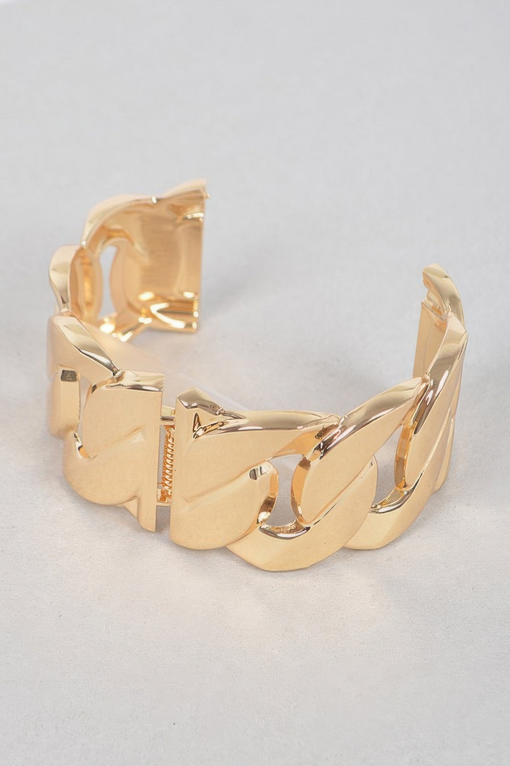 Gold chunky chain metal bracelet on a flat view, showing large linked panels