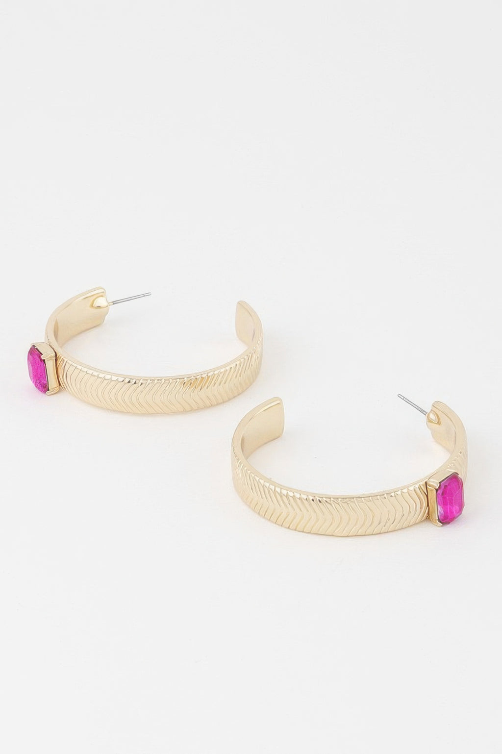 Gold hoop earrings with pink cubic rhinestone details on textured band