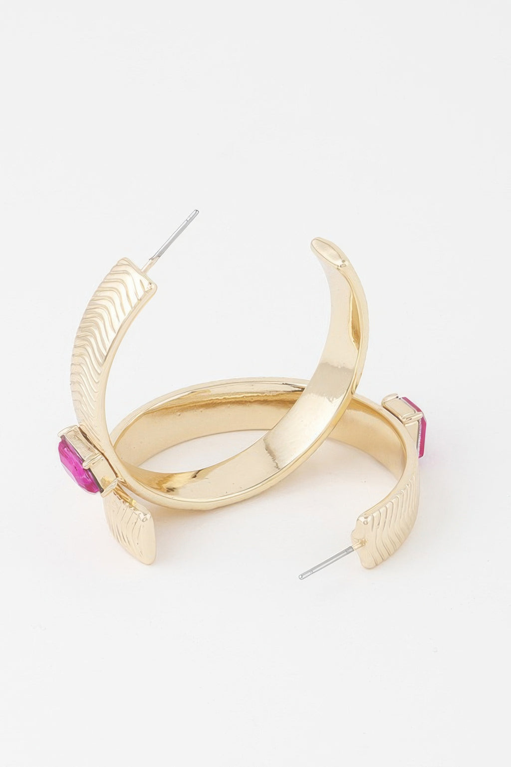 Gold hoop earrings with glossy inner curve, textured outer arc, pink rhinestone blocks