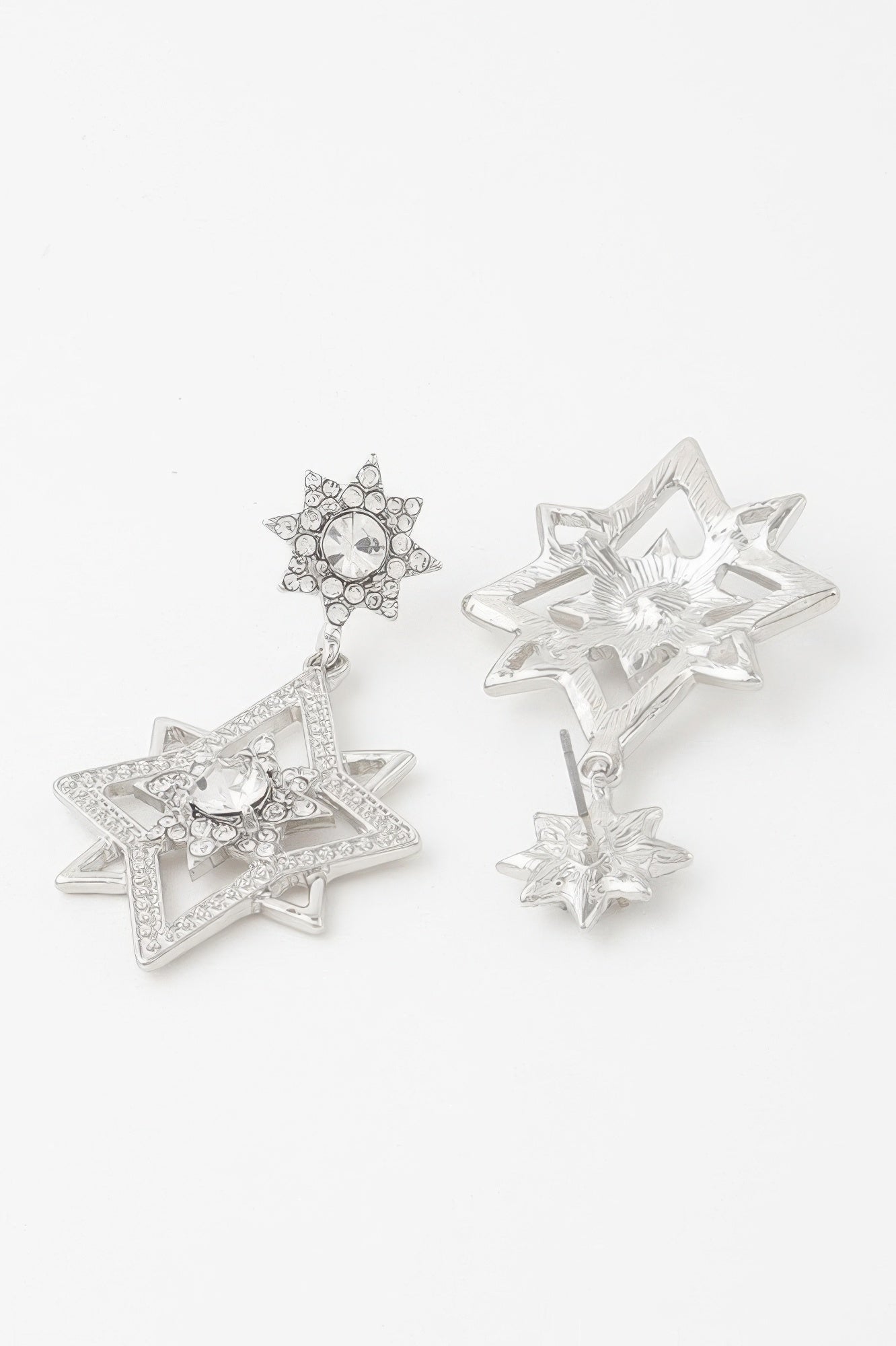 Silver-tone Shining Star dangle earrings showing open star backing and dangling drops