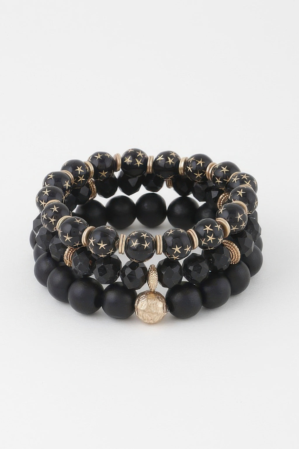 Black triple-bead bracelet with matte round beads, star discs, and center charm