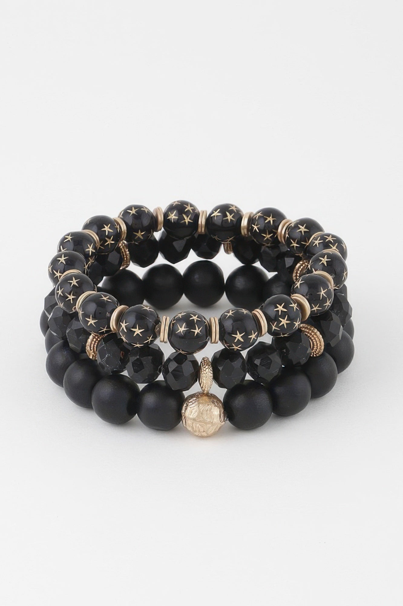 Black triple-bead bracelet with matte round beads, star discs, and center charm