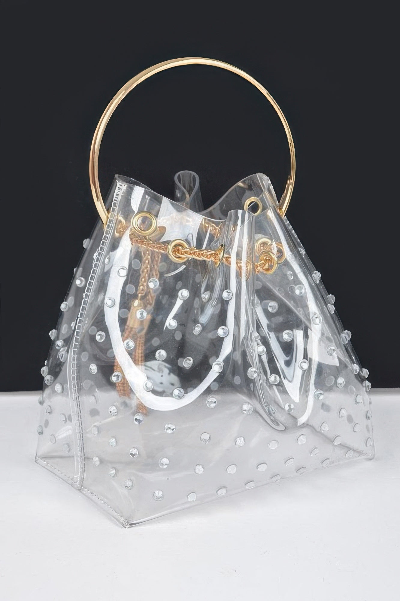 Faux pearl studded bucket bag, metal top handle and drop tassel detail