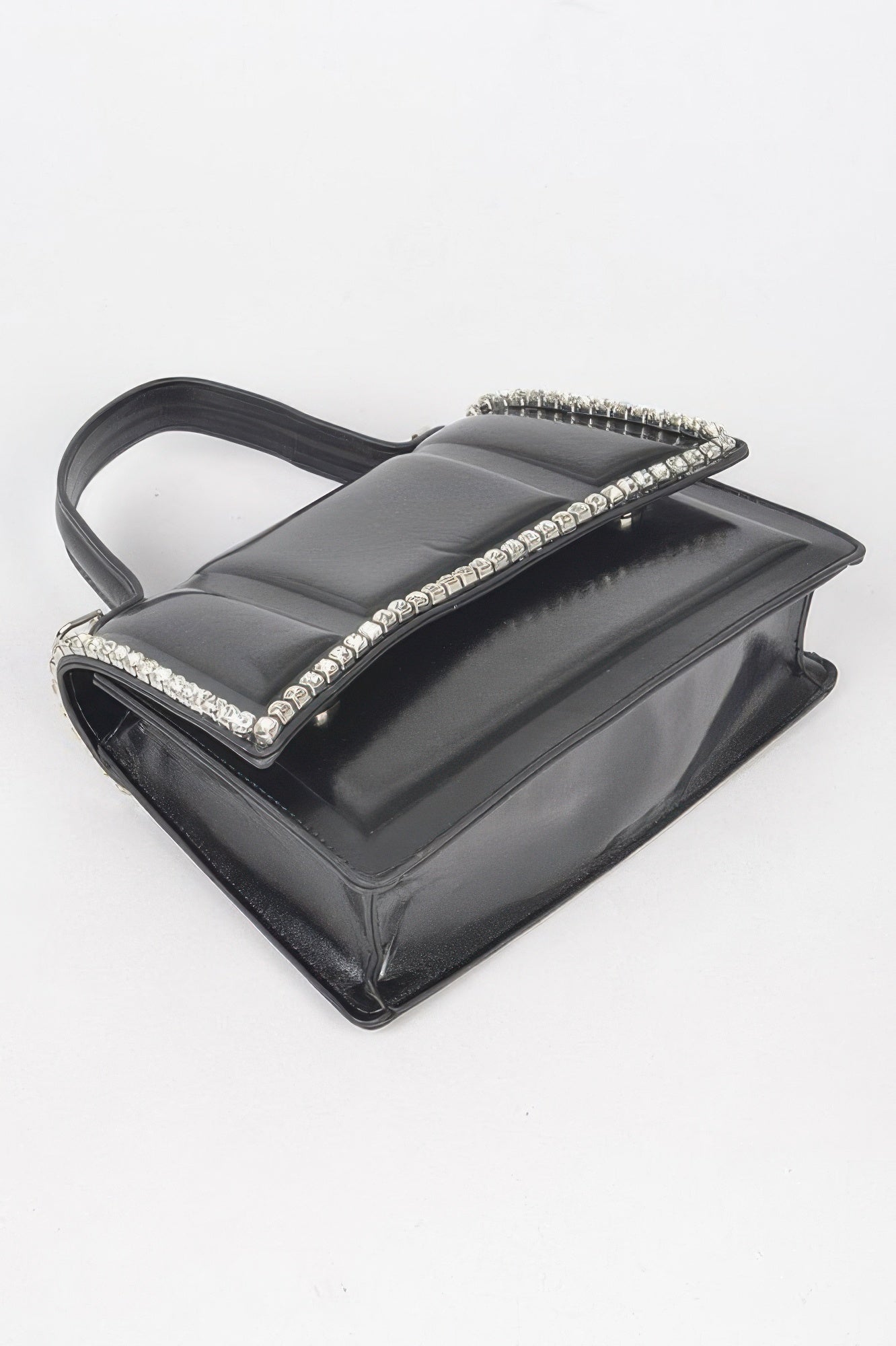Black faux leather crossbody bag with rhinestone trim along the top handle
