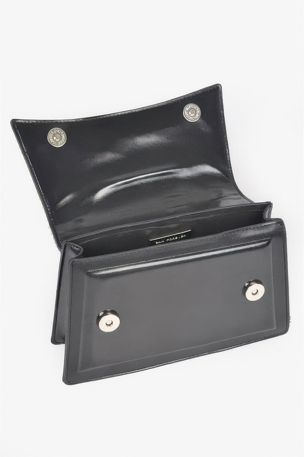 Black handbag interior view with front pocket, magnetic snap, and two button clasps