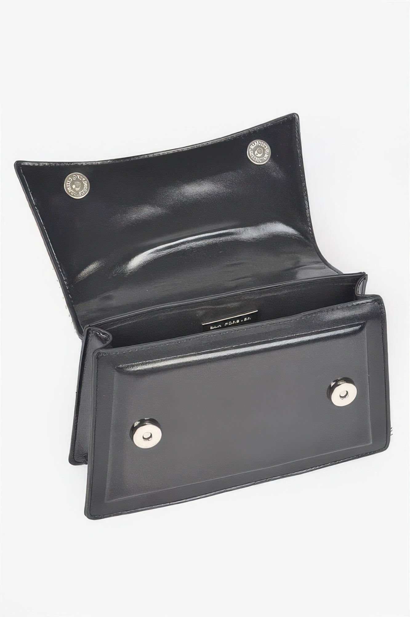 Black handbag interior view with front pocket, magnetic snap, and two button clasps