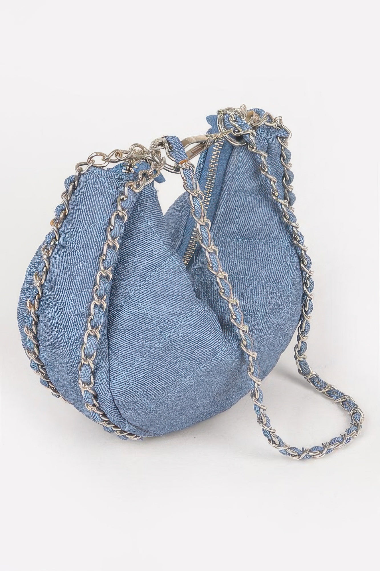 Dark blue quilted vegan denim crossbody bag with cinched top and dangling chain handles