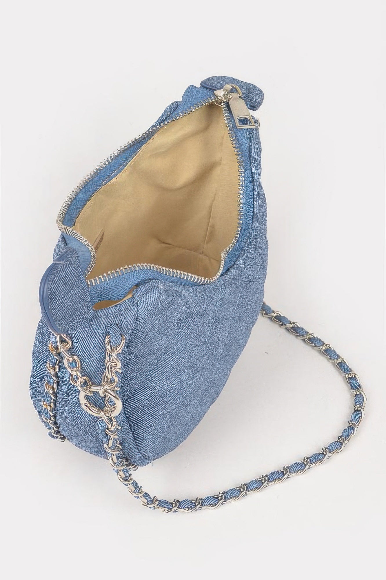 Dark blue vegan denim crossbody bag interior with zip opening and chain shoulder strap