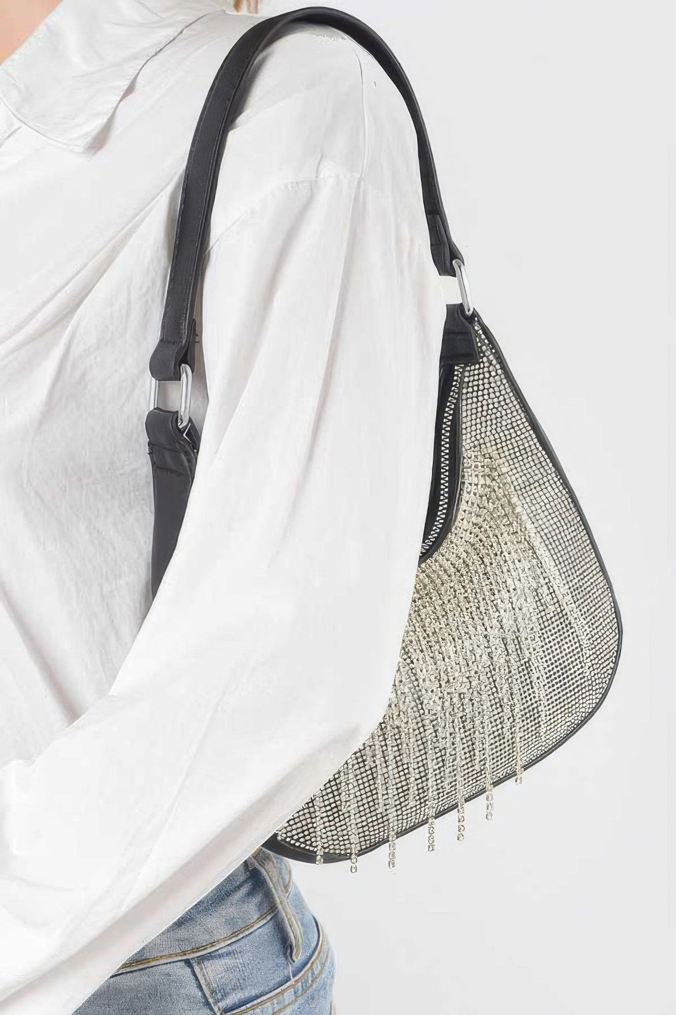 Silver rhinestone fringe hobo bag with black straps and hanging chain drops.