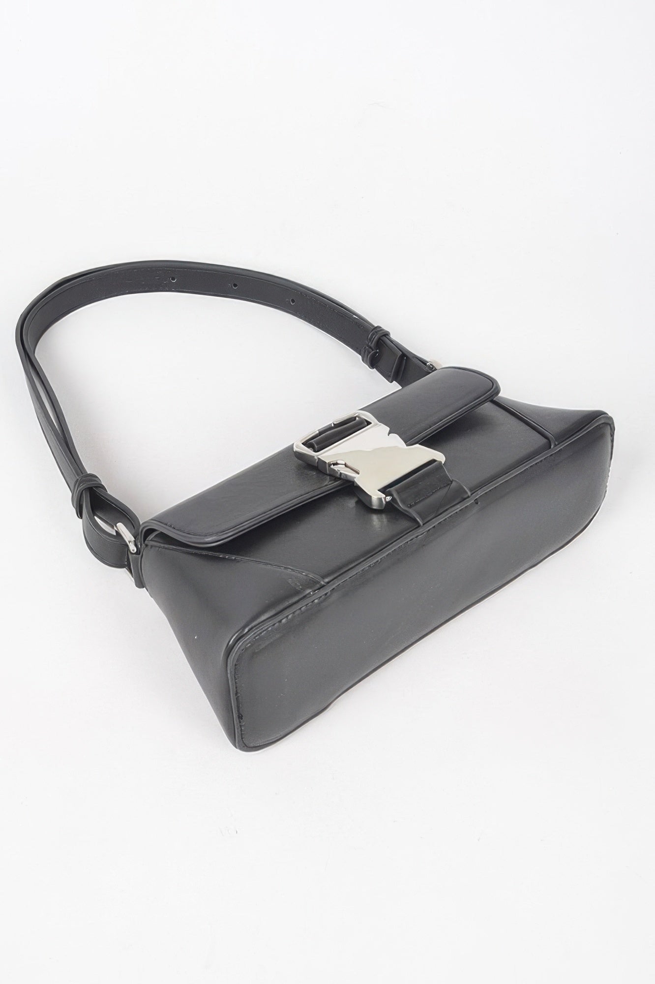 Black faux leather shoulder bag, top view with metal buckle and strap