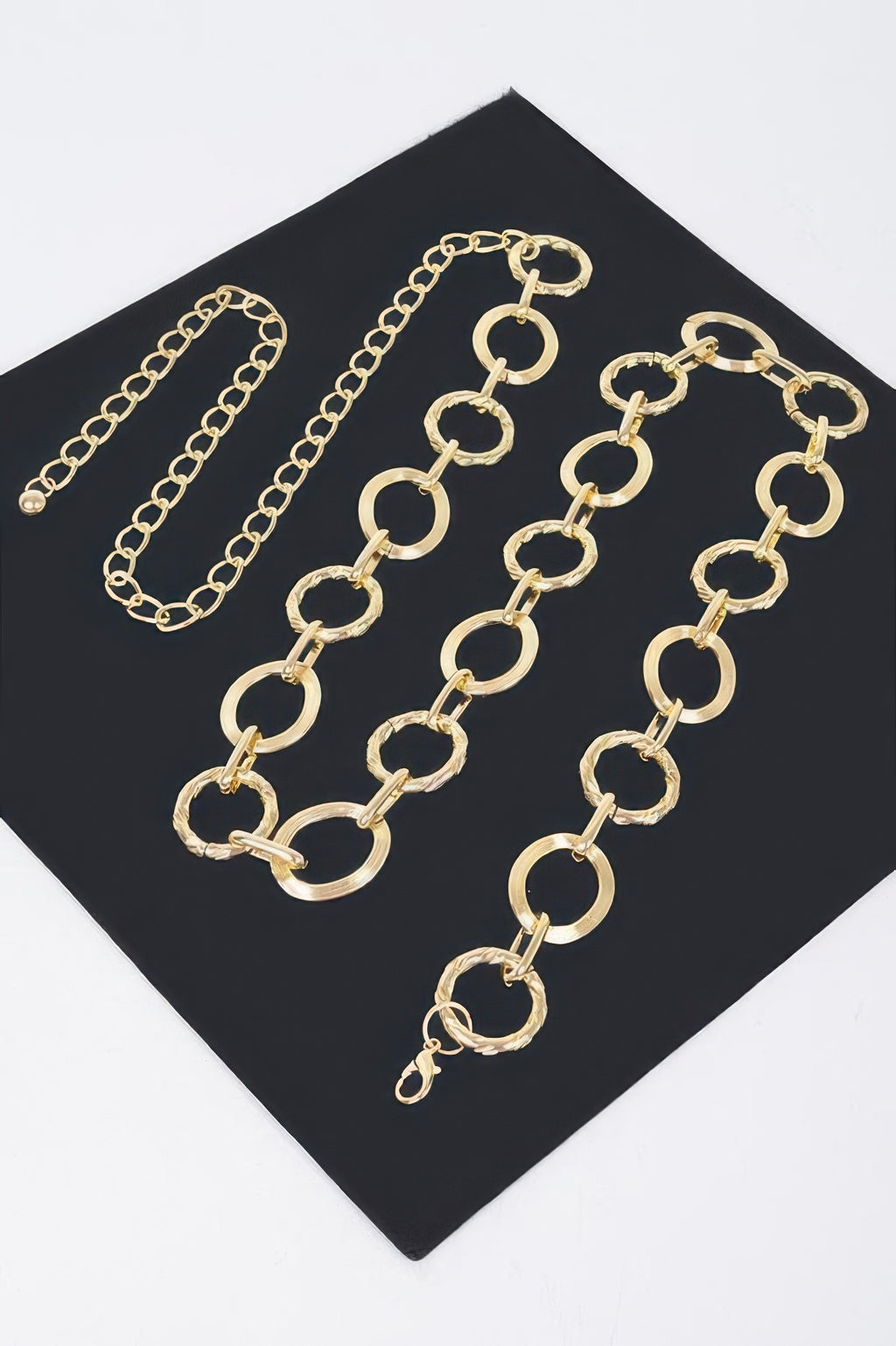 Gold round chain belt close-up on black card