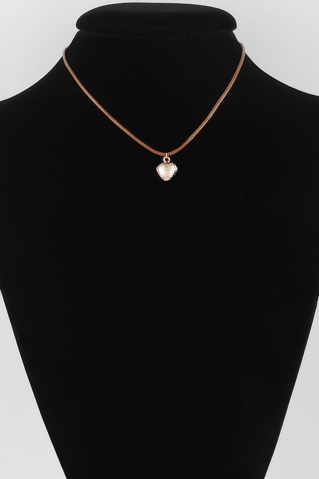 Heart pendant necklace on black cord with rose-gold tone heart charm