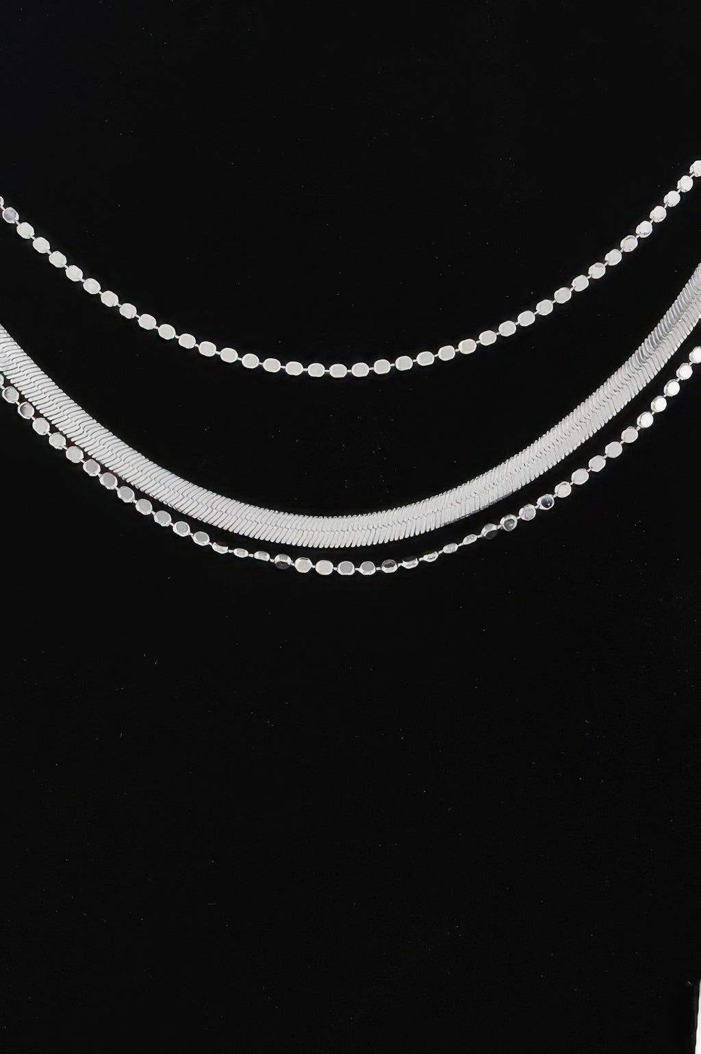 Silver triple snake chain necklace with two stacked rows of bead-like links