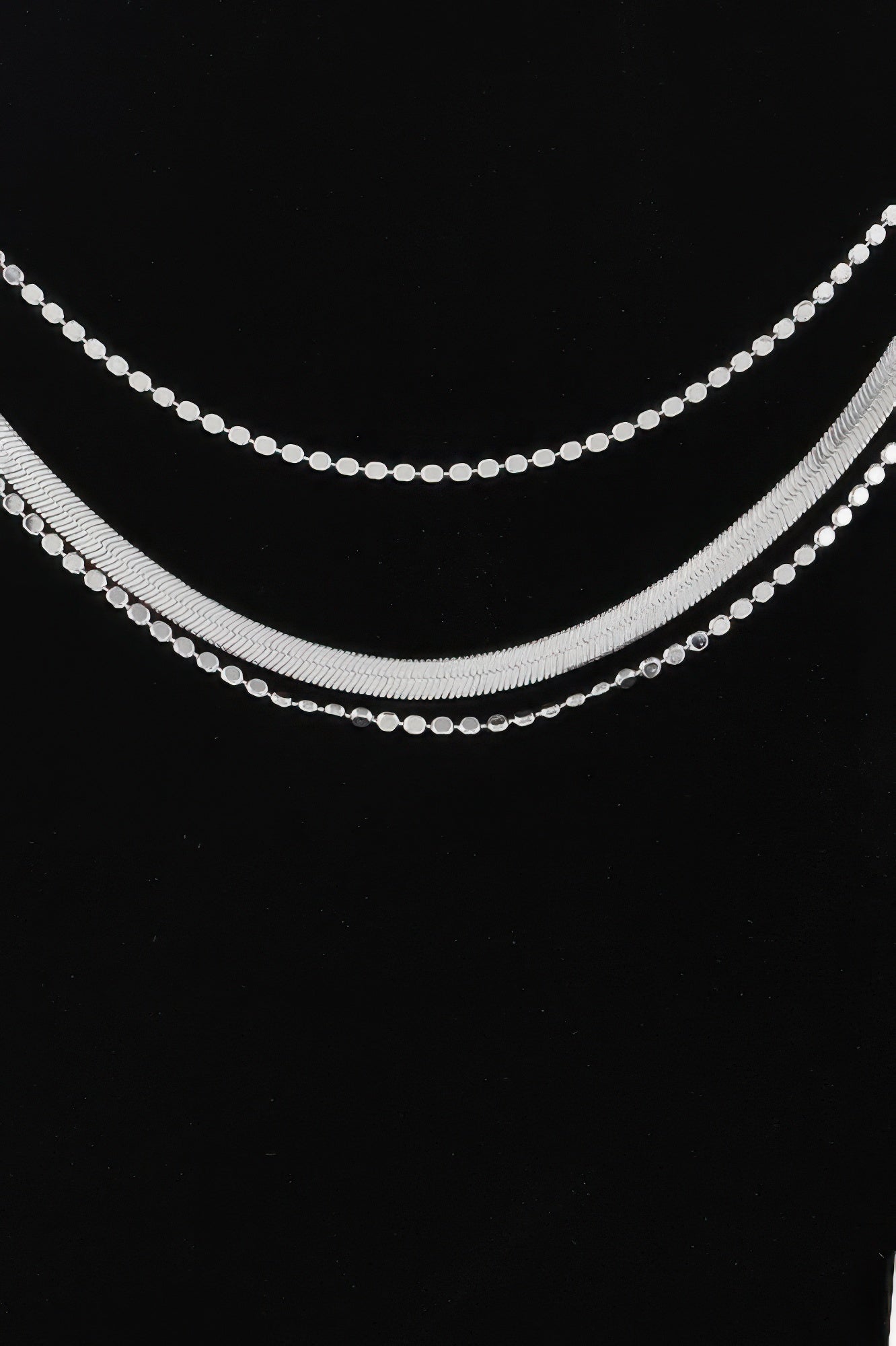 Silver triple snake chain necklace with two stacked rows of bead-like links
