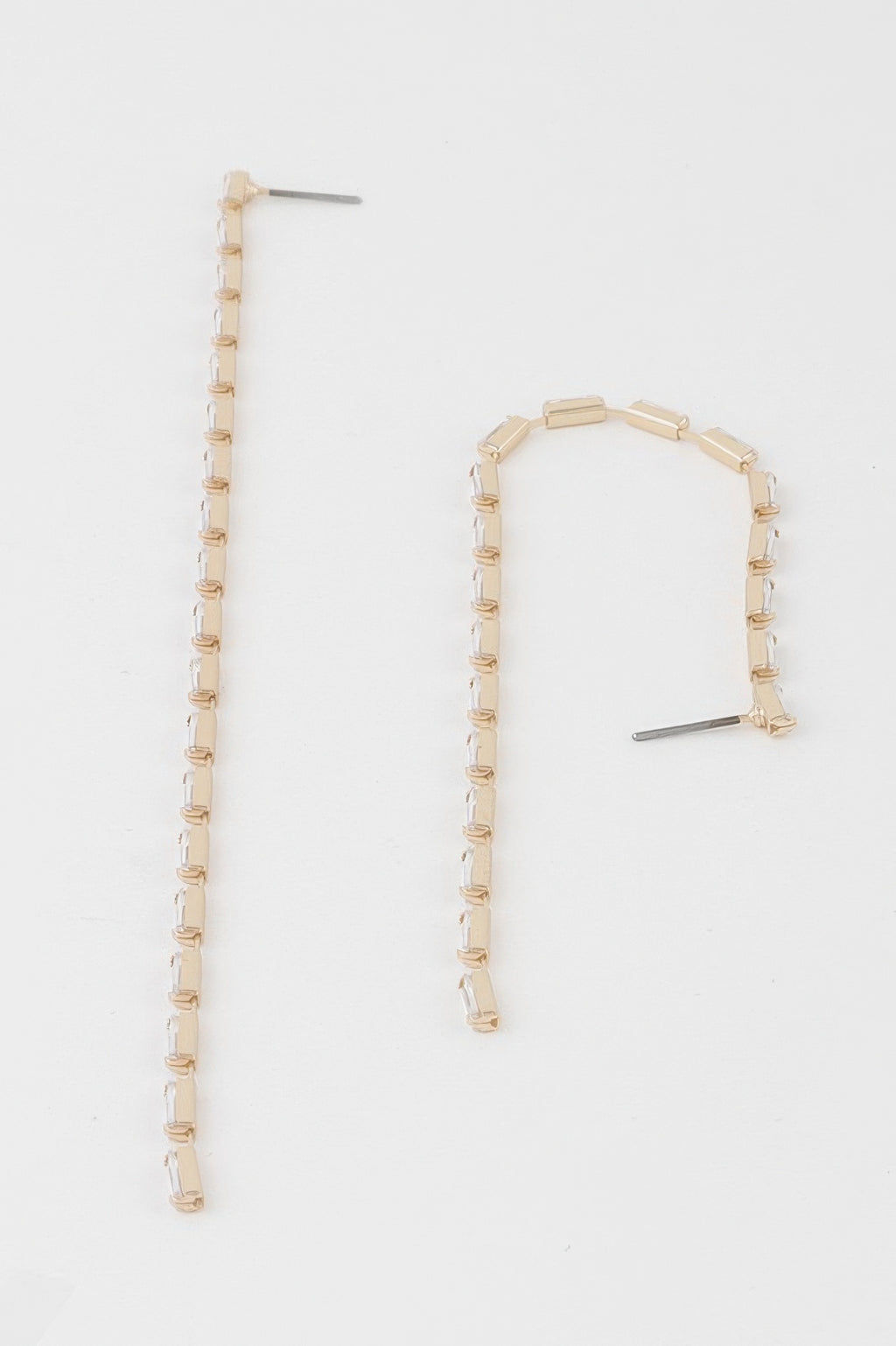 Long crystal bar drop earrings with gold-tone links and clear stones, one shown at angle
