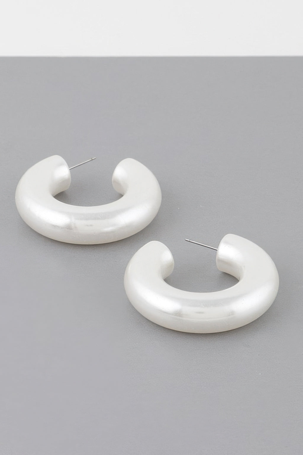 Bulky cream polished hoop earrings with straight stud posts