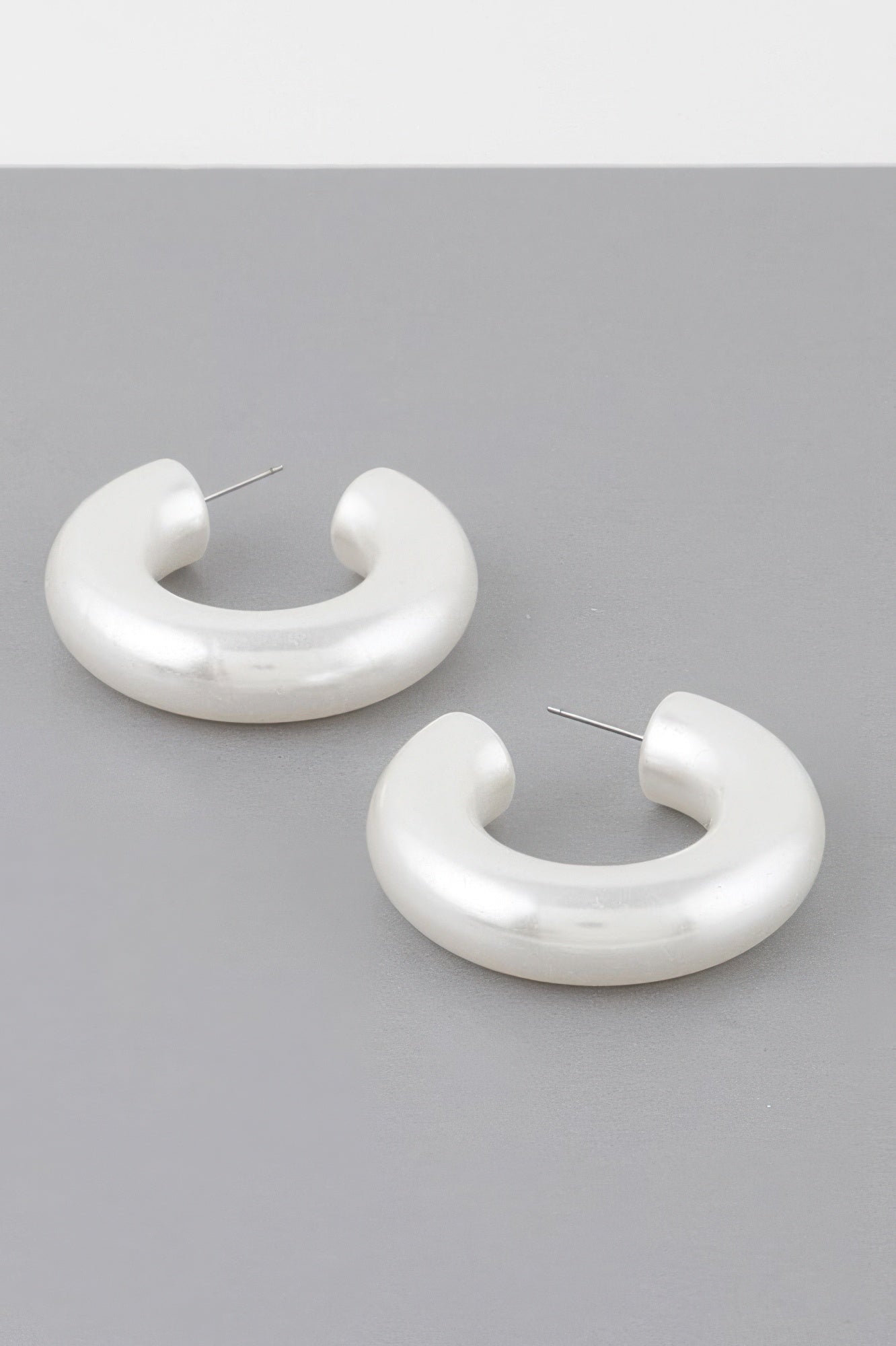 Bulky cream polished hoop earrings with straight stud posts
