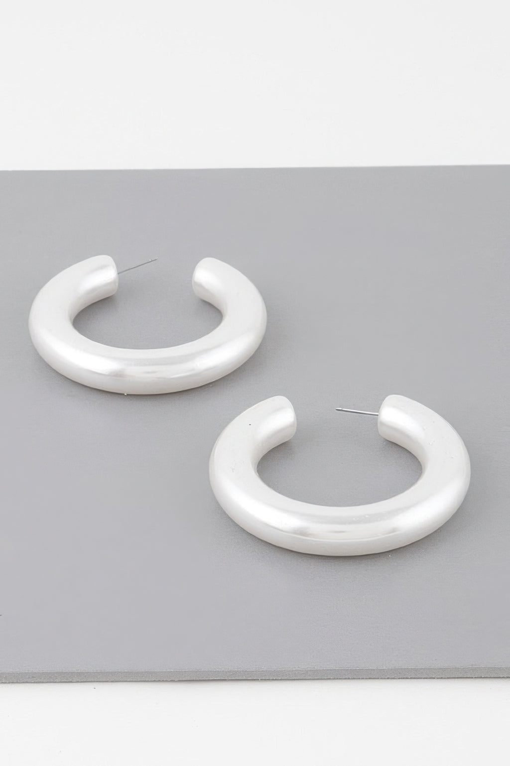 Polished cream hoop earrings, two curved hoops with stud backs