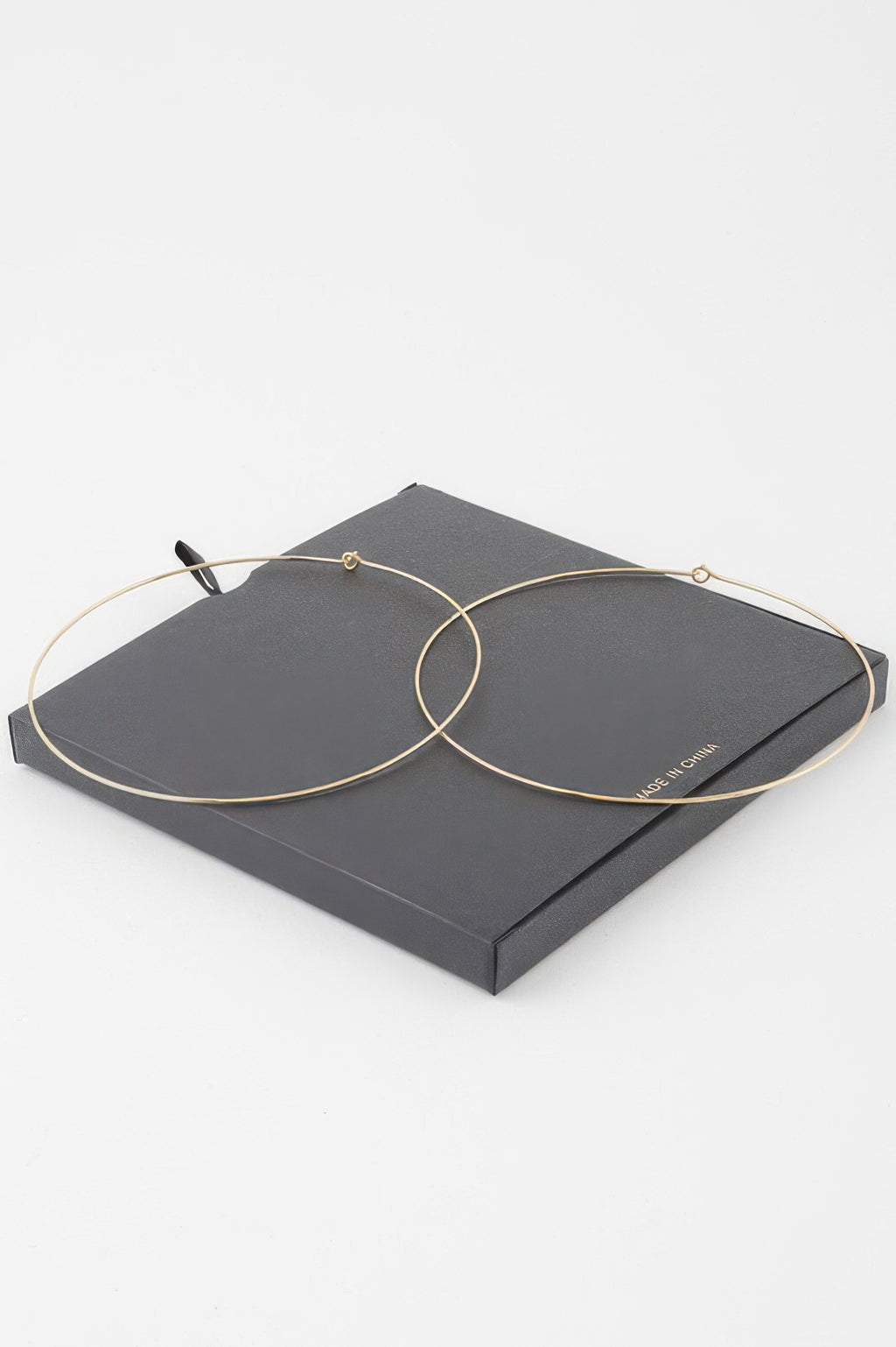 Gold flat hoop earrings, overlapping hoops with small backing hooks