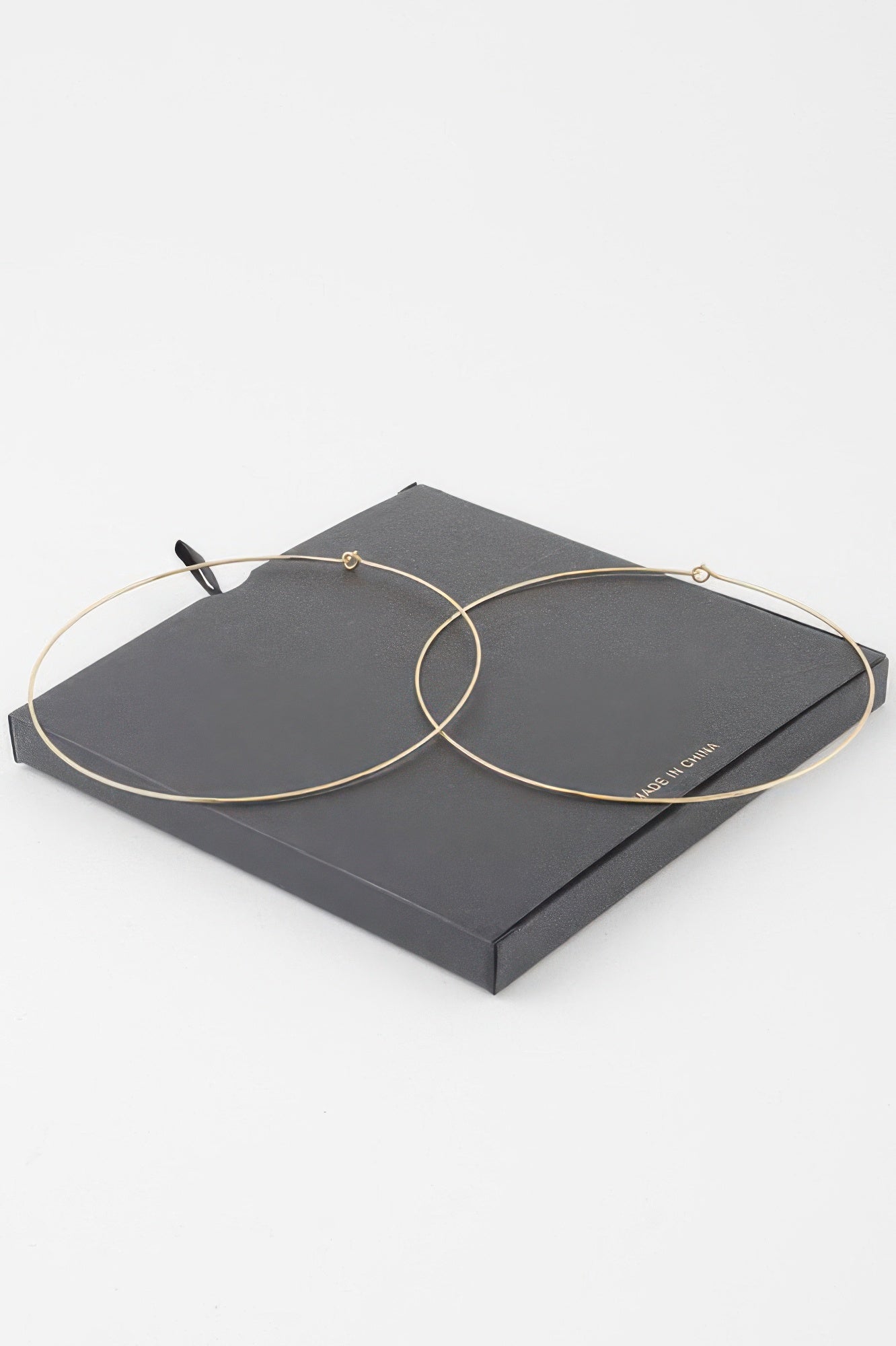 Gold flat hoop earrings, overlapping hoops with small backing hooks