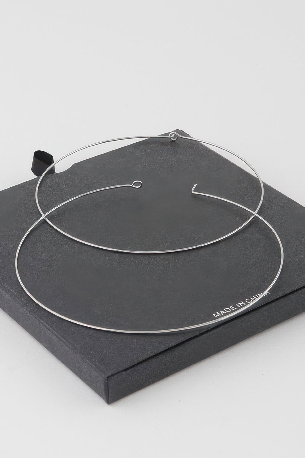 Wide silver-dipped flat hoop earrings with simple hook closures
