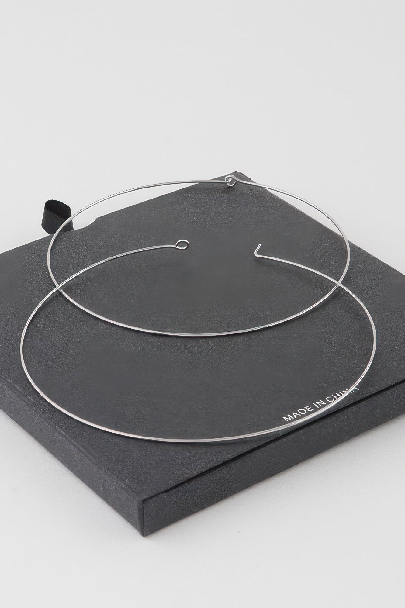 Wide silver-dipped flat hoop earrings with simple hook closures