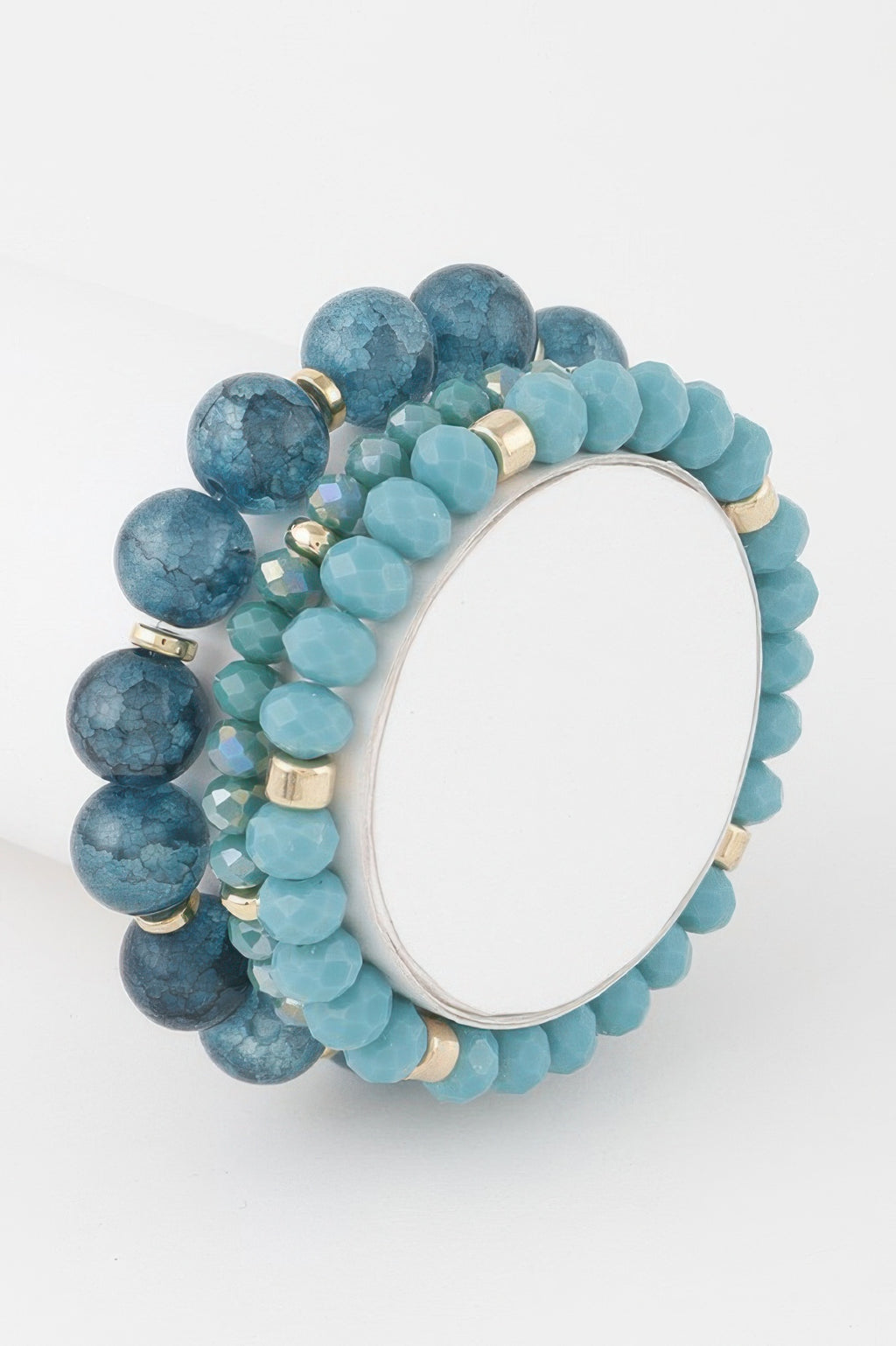 Triple crystal beaded bracelet in blue/teal tones with gold-tone accents