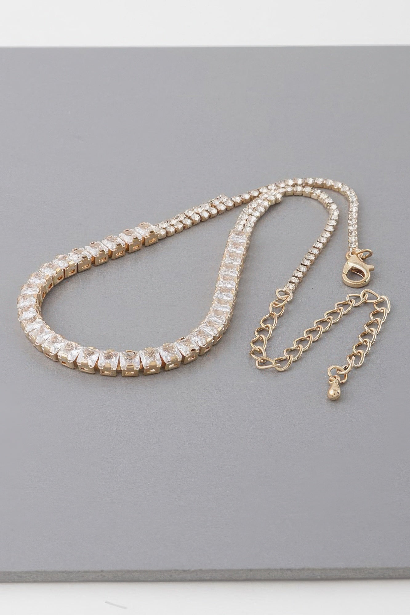 Gold-tone cubic rhinestone choker necklace with extender chain