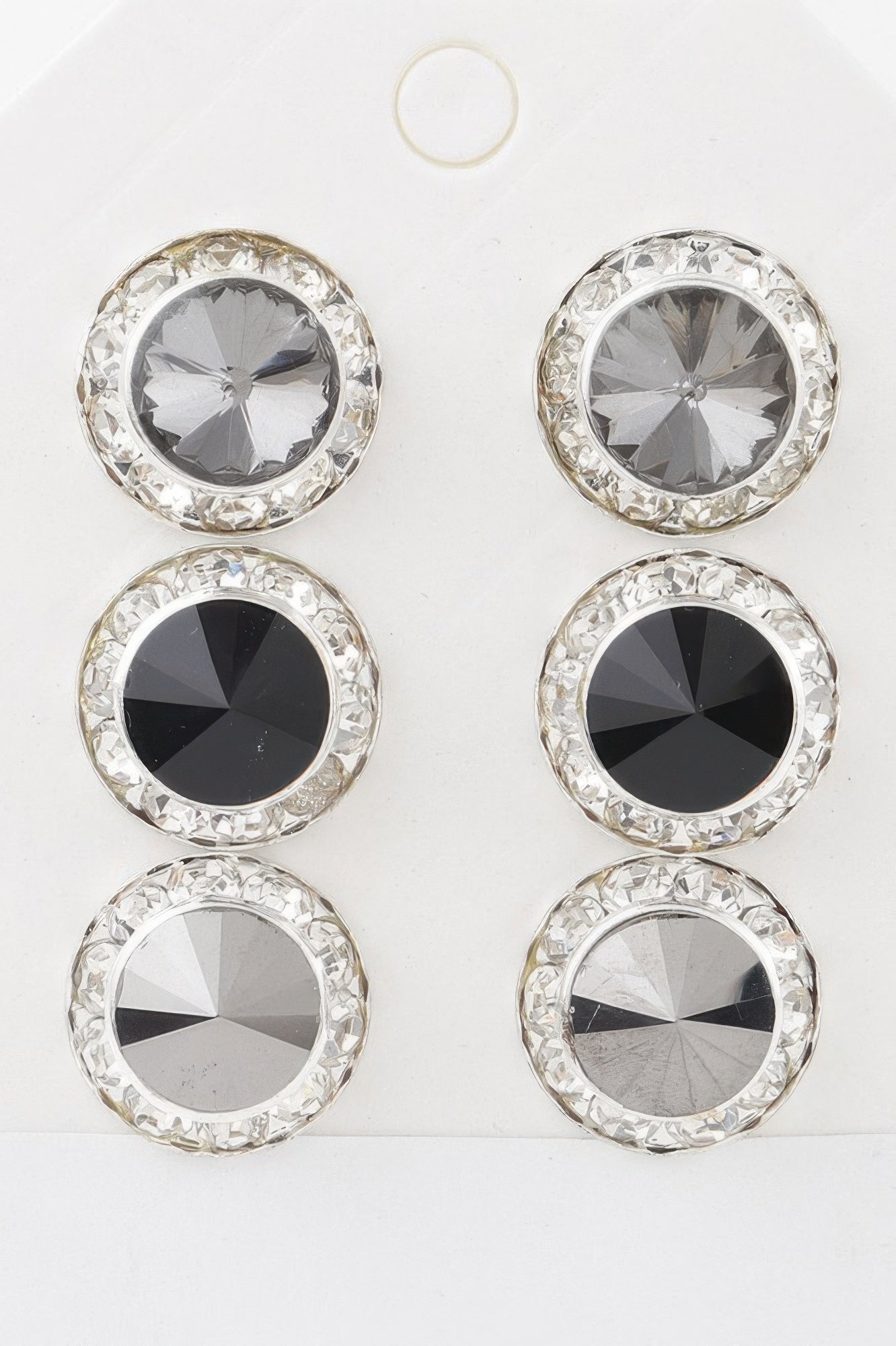 Triple jeweled stud set: clear/gray, dark, and light stones in silver-tone bezels