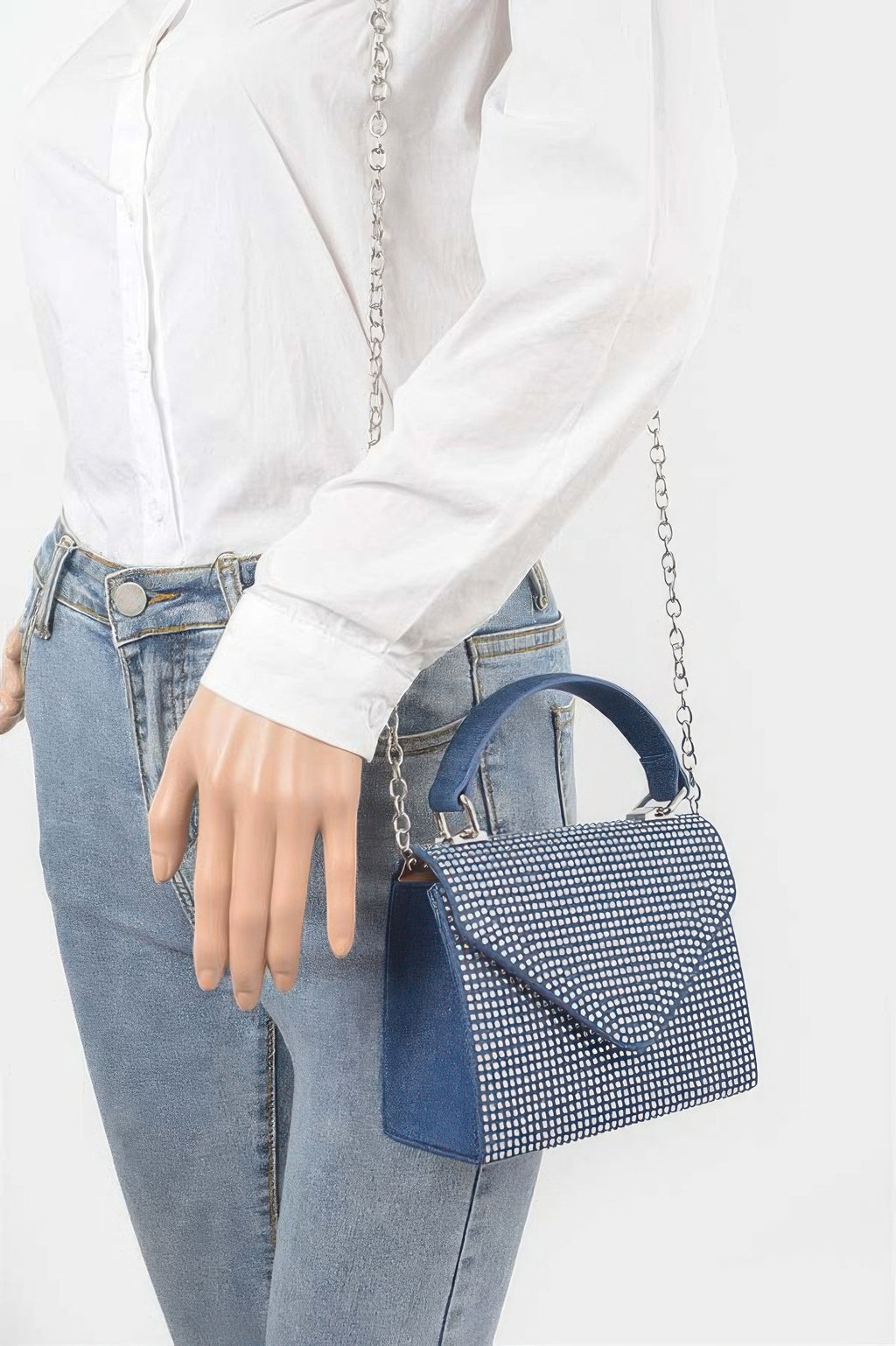 Dark blue hot-fix stone top handle bag with silver dot pattern, worn crossbody with chain