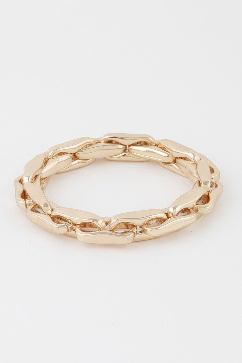 Gold chain bracelet with hammered oval links and wide cuff-like fit, polished