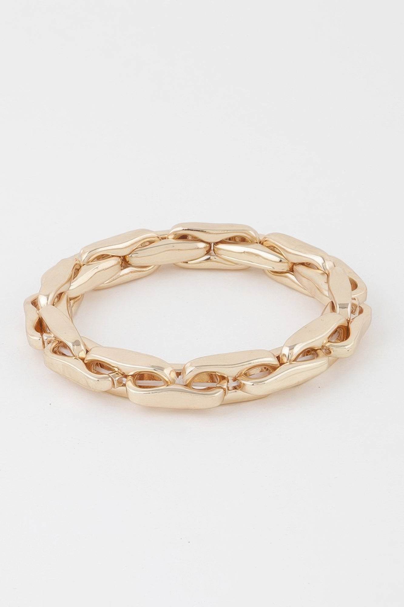 Gold chain bracelet with hammered oval links and wide cuff-like fit, polished