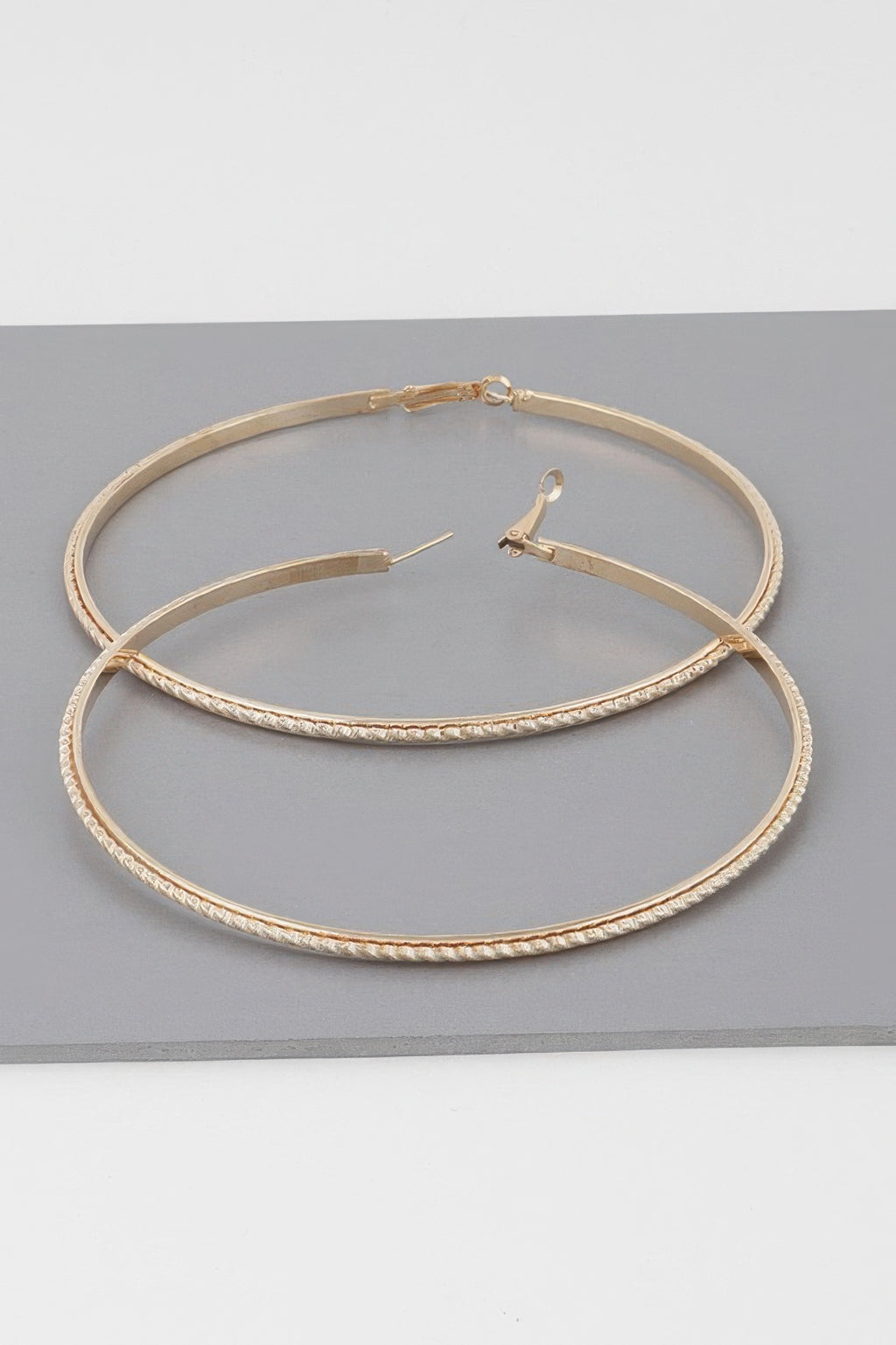 Wide 3.8" double-twisted hoop earrings, gold tone, hinged clasp