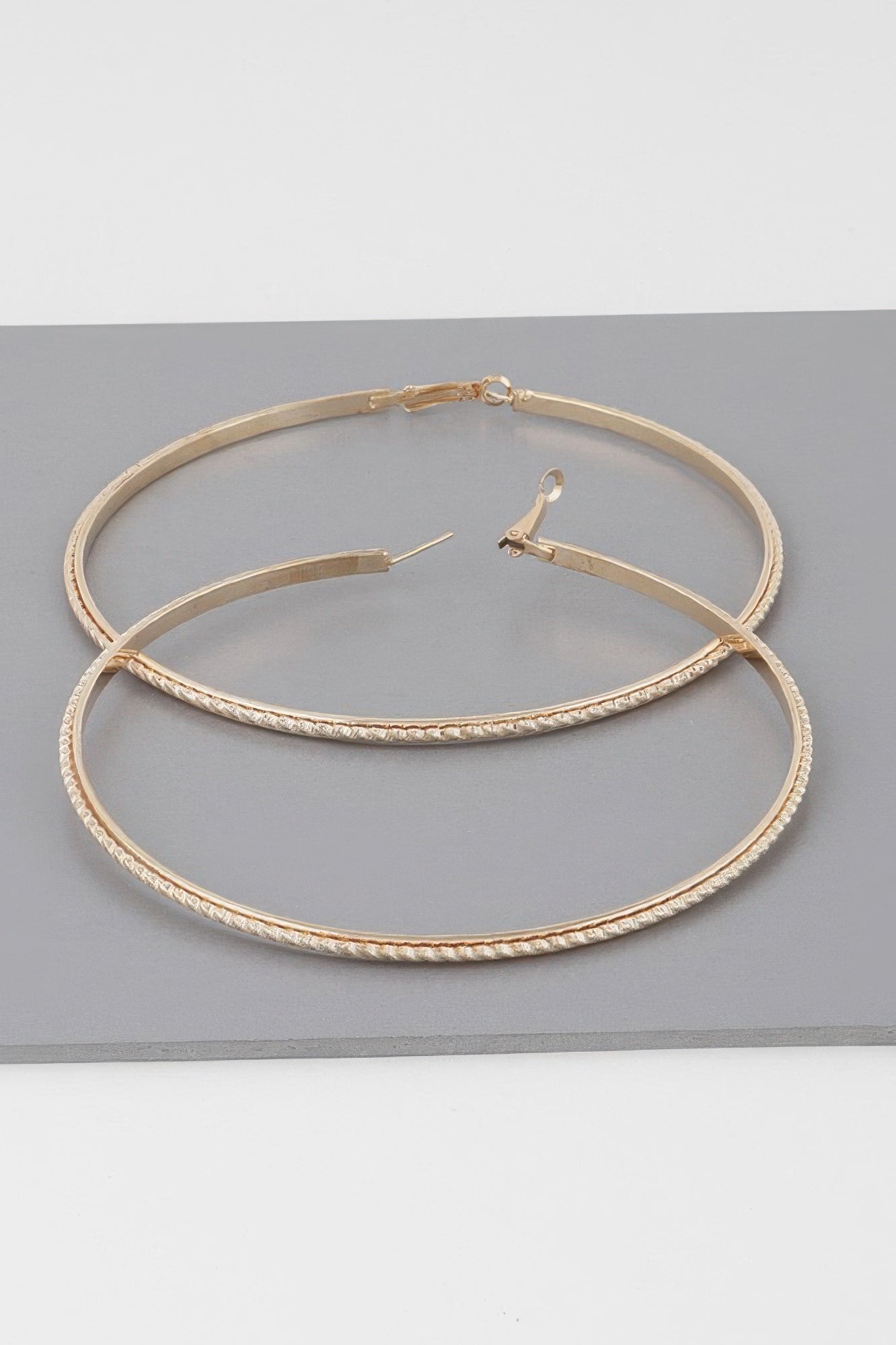Wide 3.8" double-twisted hoop earrings, gold tone, hinged clasp