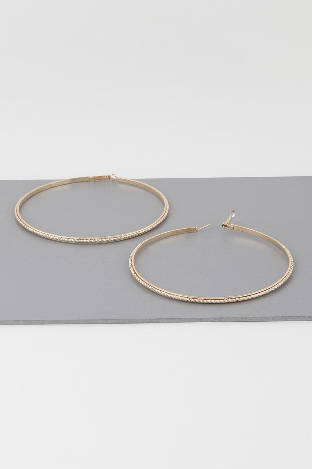 Wide double-twisted hoop earrings, gold tone, pair with hook closures