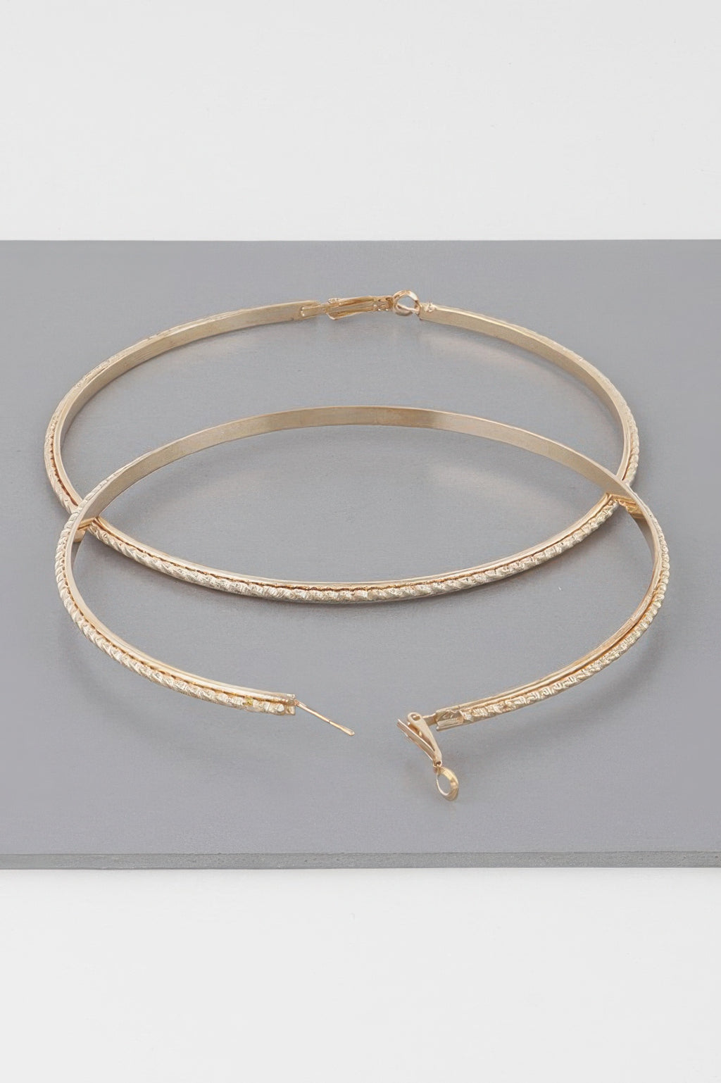 Wide 3.8" double-twisted hoop earrings, gold tone, detailed clasp and post