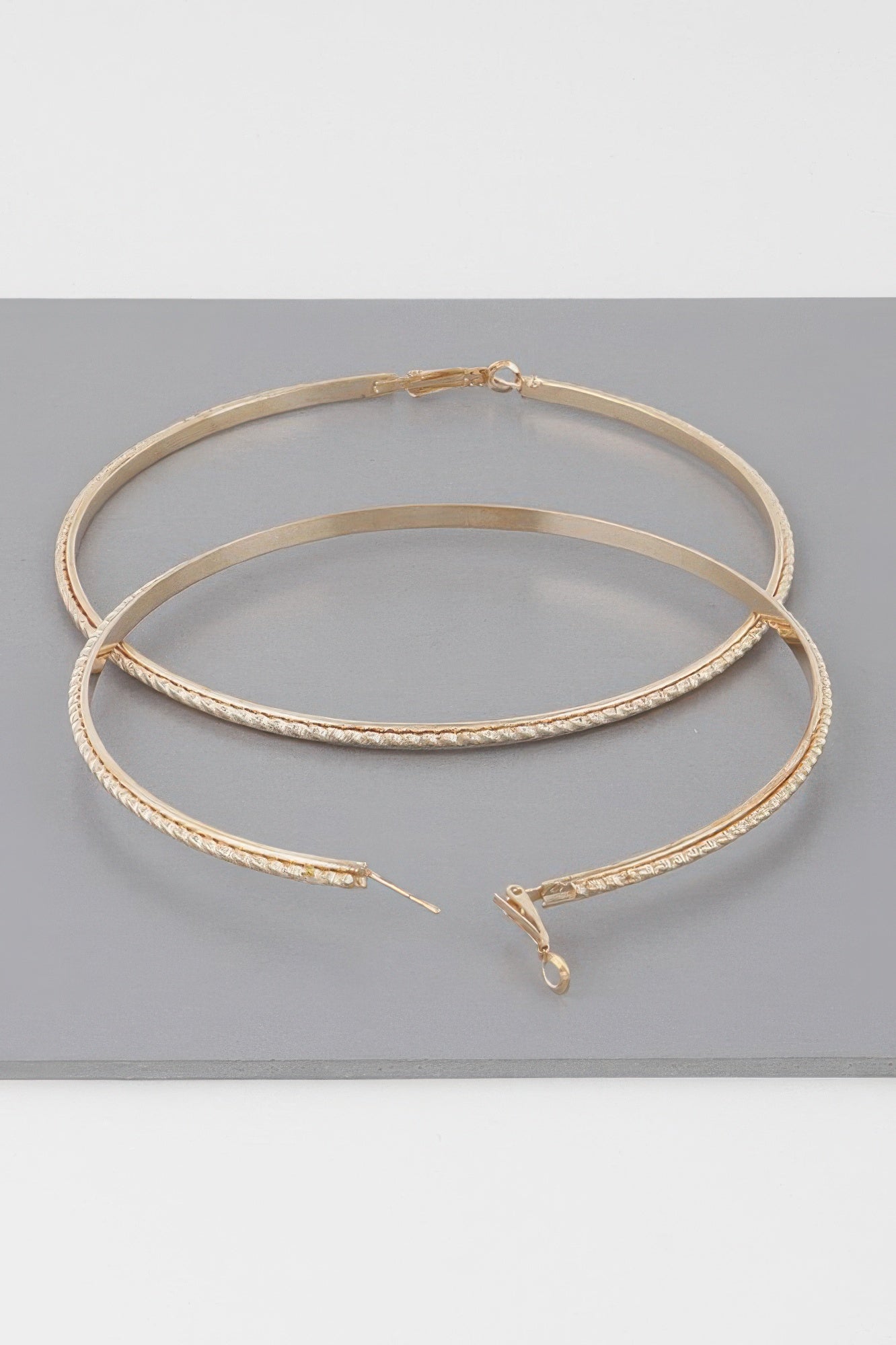 Wide 3.8" double-twisted hoop earrings, gold tone, detailed clasp and post