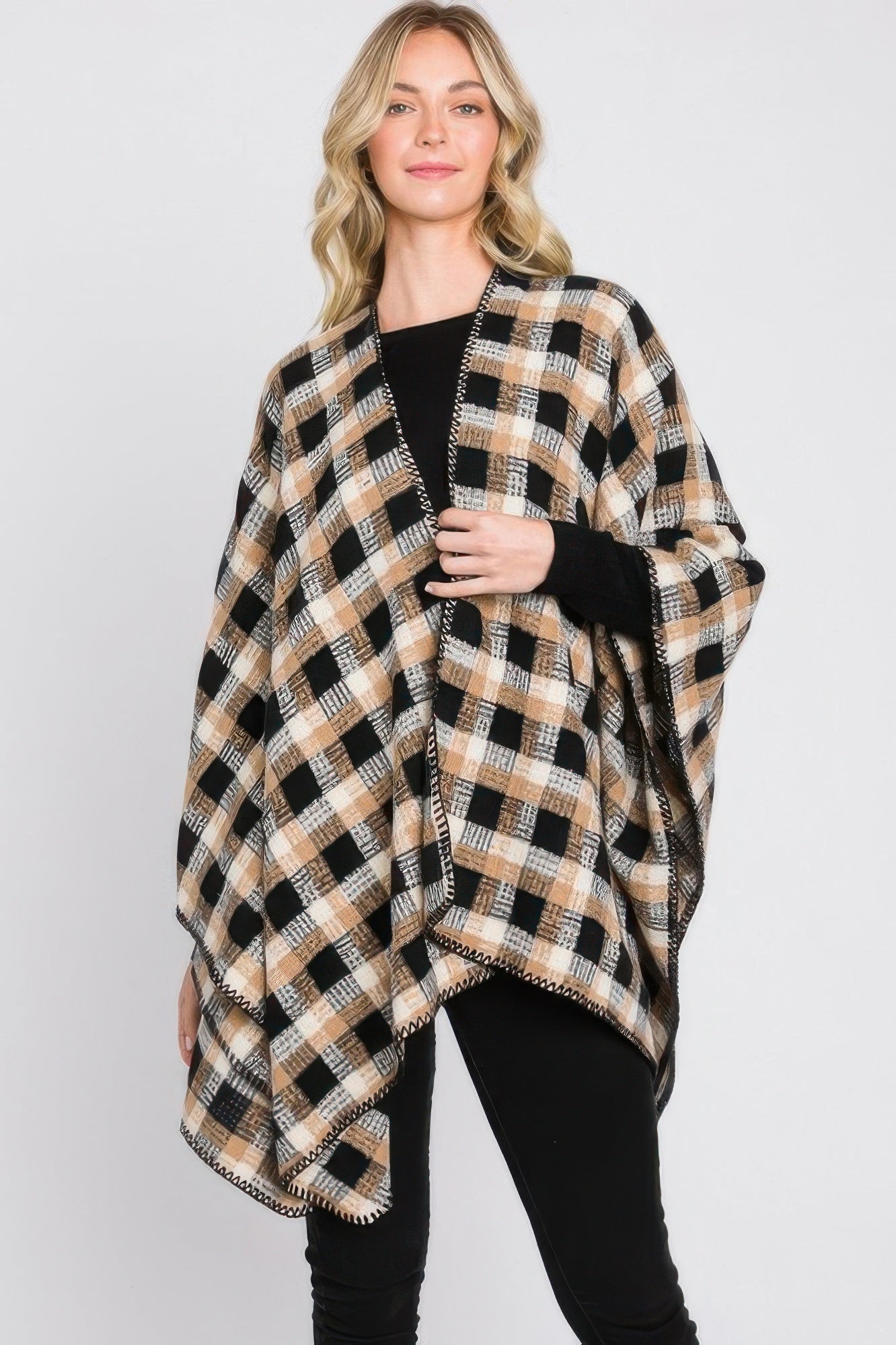 Plaid ruana with black, tan, and white check pattern, open draped front