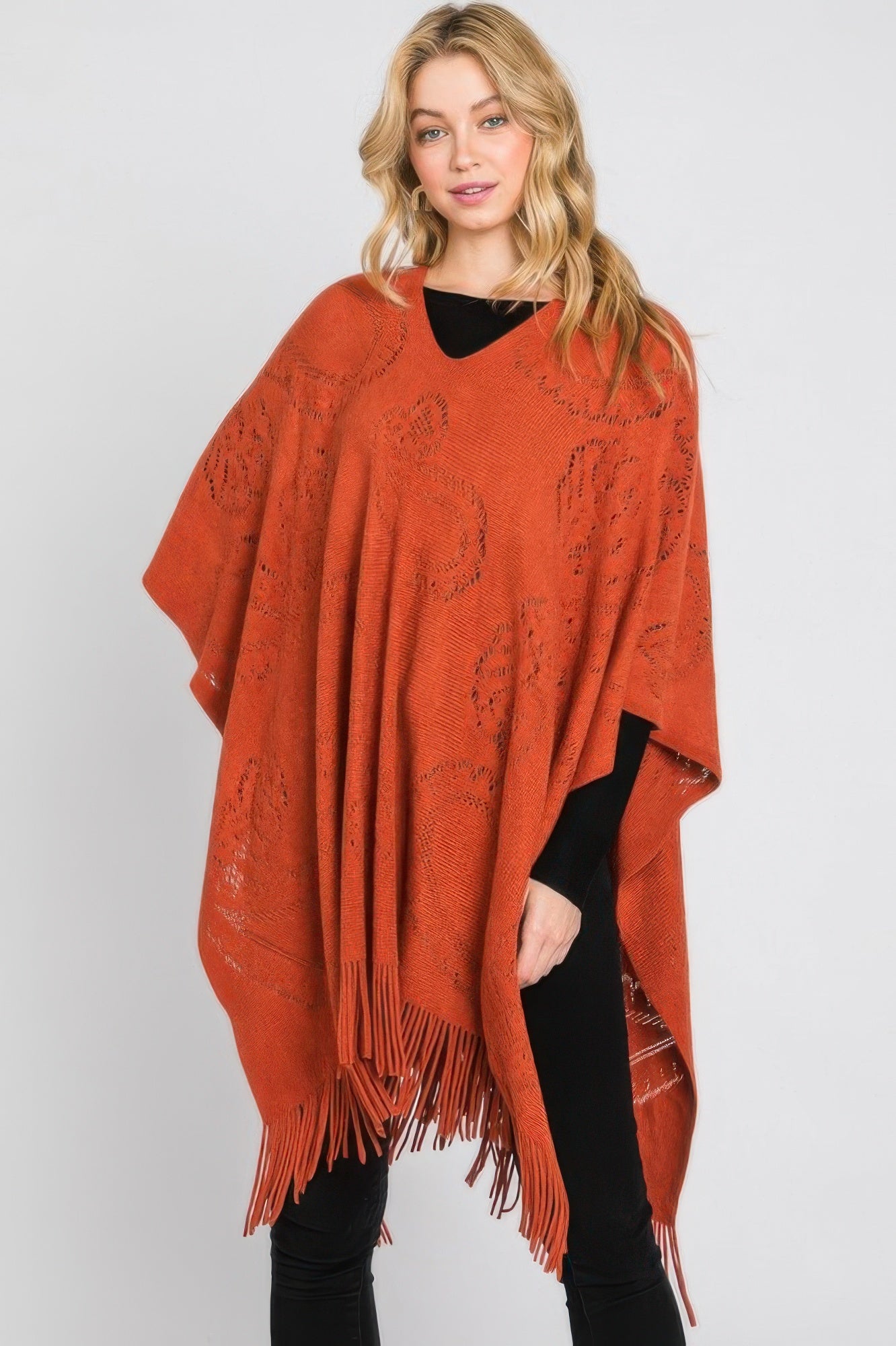 Paisley Pattern Fringe Poncho in Rust orange, loose poncho silhouette with fringe trim.