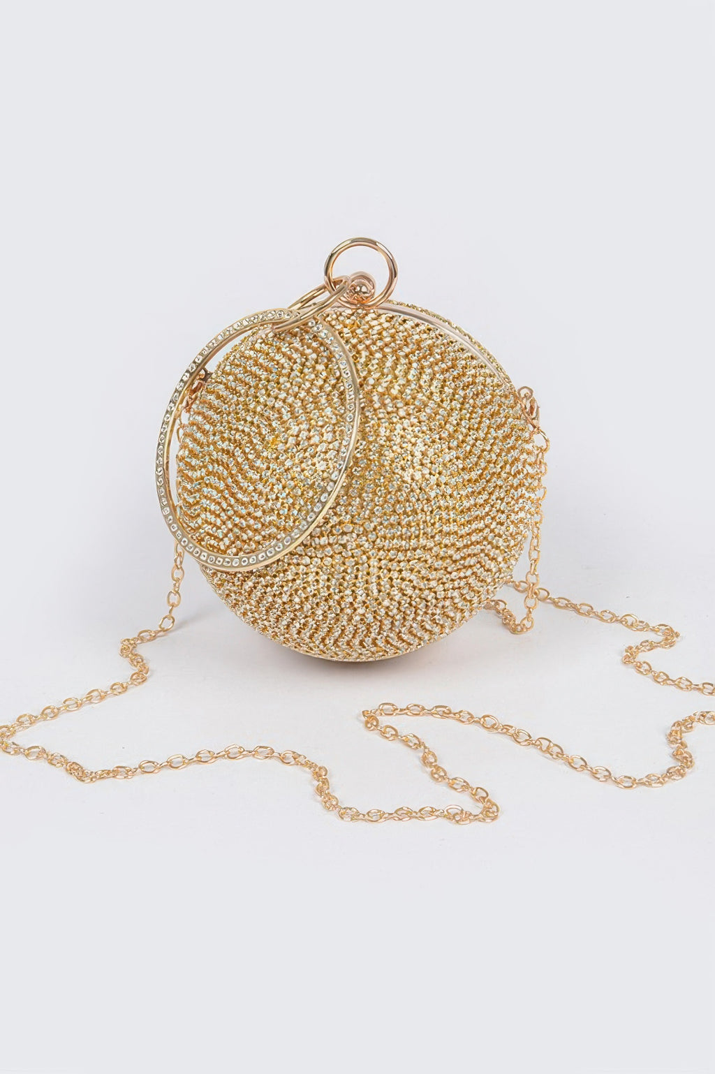 Gold rhinestone ball clutch with round hinged frame and long chain strap