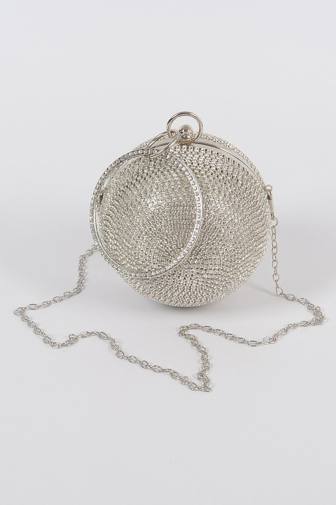 Silver rhinestone ball clutch with dangling chain and round hinged frame