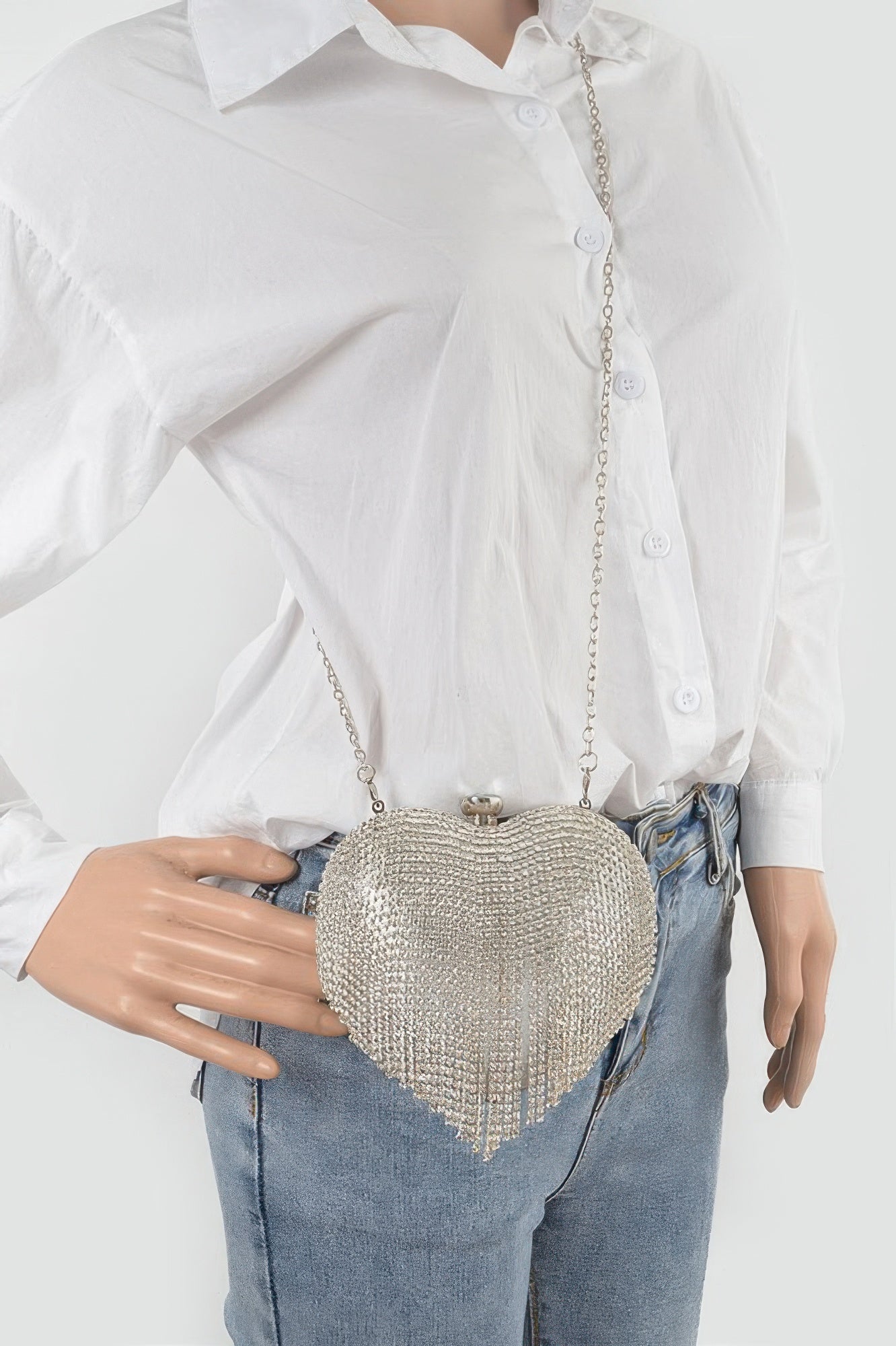 Silver rhinestone heart mini bag on chain strap worn with denim