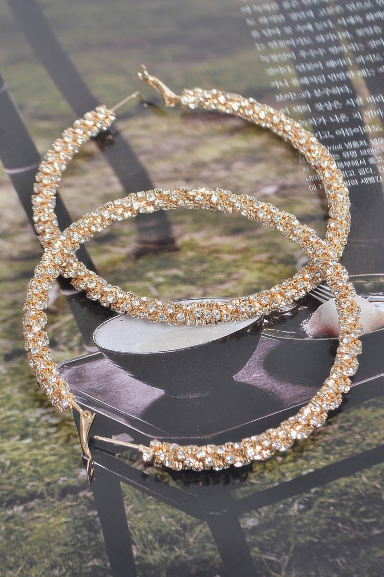 Gold-tone twisted rhinestone hoop earrings, large round hoops with rhinestone sparkle